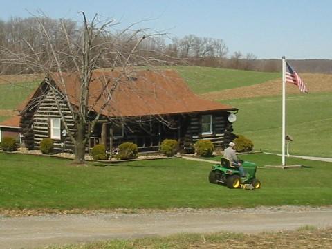 Photo of: The state treasurer of the KKK mowing his lawn.  He lives accross the road from the driveway.