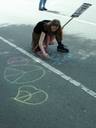 Thumbnail of: Girl peacechalking on the road